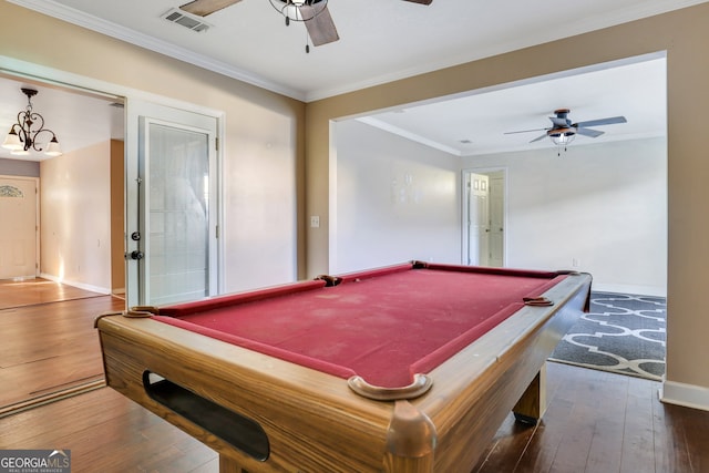 game room with dark hardwood / wood-style flooring and crown molding