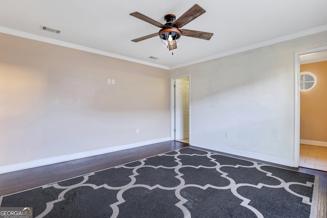 spare room featuring ornamental molding, dark hardwood / wood-style floors, and ceiling fan