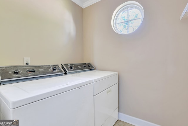 laundry area with washer and clothes dryer and ornamental molding