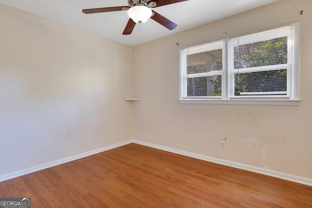 unfurnished room with hardwood / wood-style flooring and ceiling fan