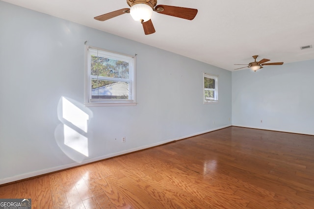 empty room featuring hardwood / wood-style flooring and ceiling fan