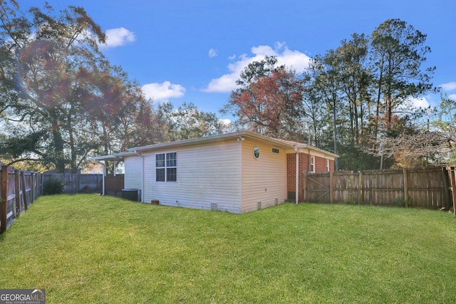 view of side of home with a yard