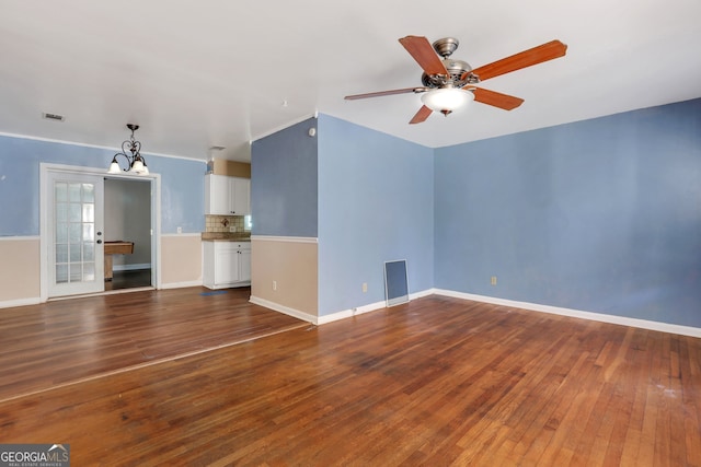 unfurnished living room with dark hardwood / wood-style flooring and ceiling fan