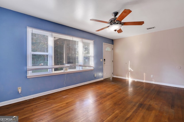 unfurnished room featuring dark wood-type flooring and ceiling fan