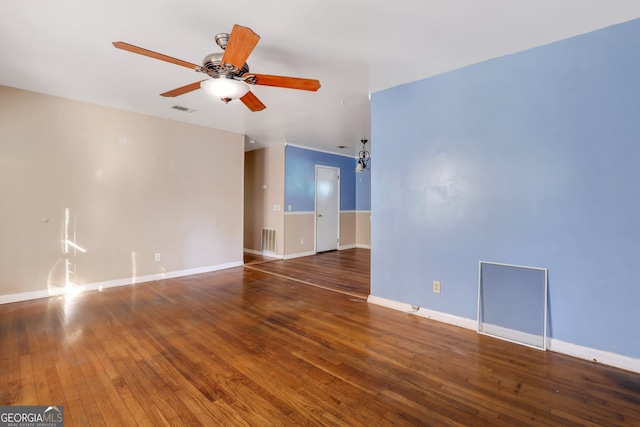 spare room with dark hardwood / wood-style floors and ceiling fan