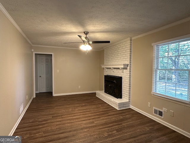 unfurnished living room with dark wood-type flooring, ceiling fan, a textured ceiling, and a brick fireplace