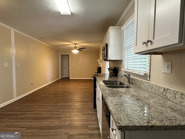 kitchen featuring sink, dark hardwood / wood-style floors, light stone countertops, white cabinetry, and appliances with stainless steel finishes