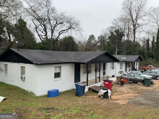 ranch-style house with cooling unit and a front yard