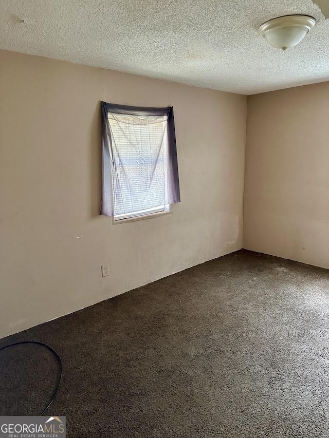 2155 Ferguson St, Macon, GA 31204 - empty room with carpet flooring and a textured ceiling