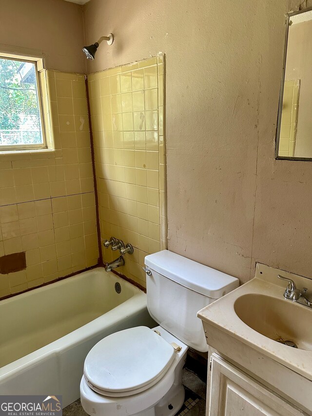 full bathroom featuring vanity, toilet, and tiled shower / bath combo