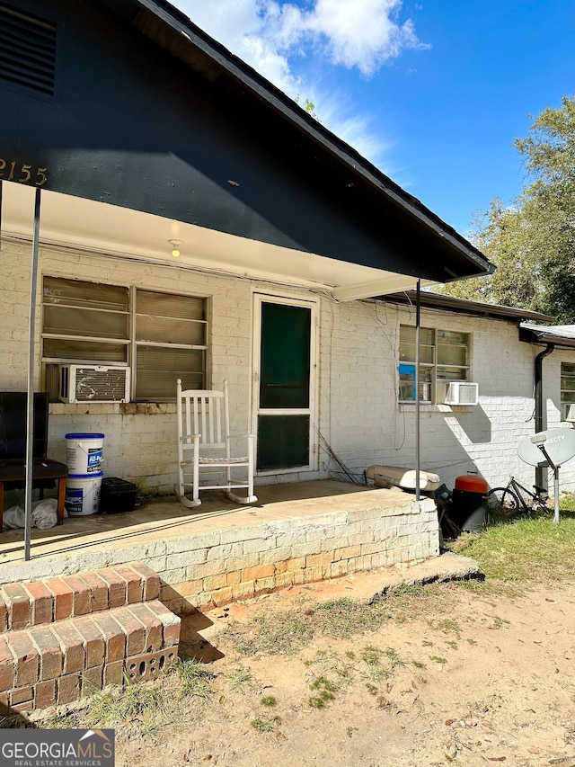 back of property featuring cooling unit and a patio