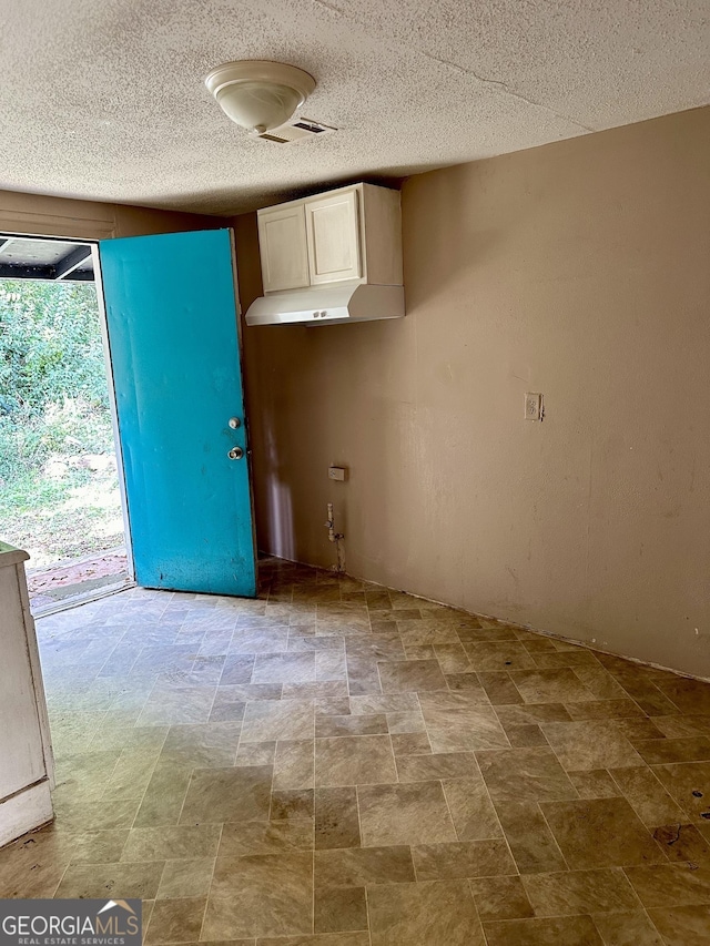 2155 Ferguson St, Macon, GA 31204 - kitchen with white cabinetry and a textured ceiling