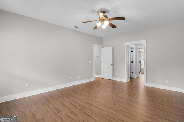 unfurnished bedroom featuring dark hardwood / wood-style flooring and ceiling fan