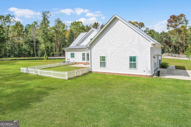 rear view of house with a yard