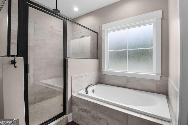 bathroom with plus walk in shower and a wealth of natural light