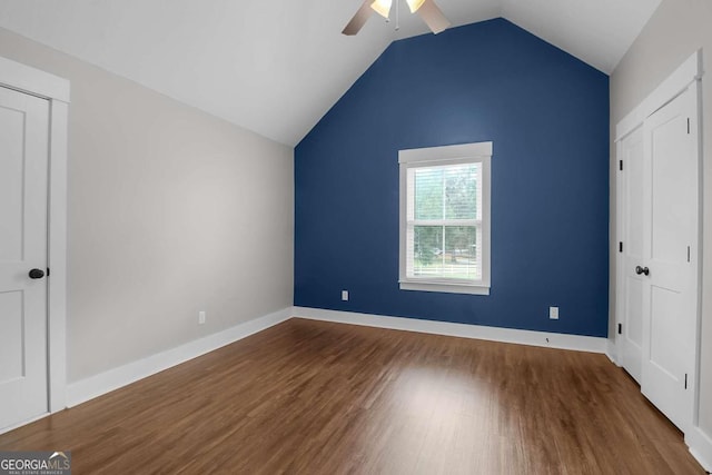 unfurnished bedroom featuring lofted ceiling, hardwood / wood-style flooring, and ceiling fan