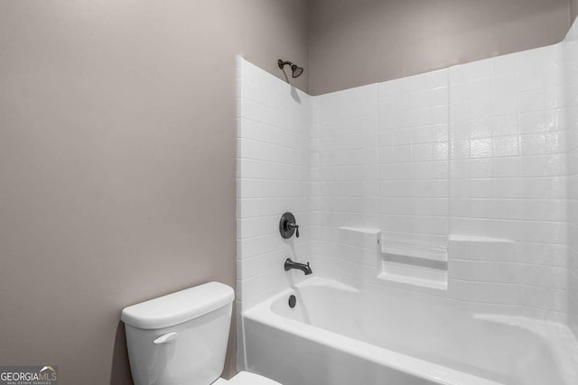 bathroom featuring shower / bathing tub combination and toilet