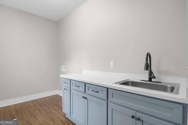 kitchen featuring dark wood-type flooring and sink