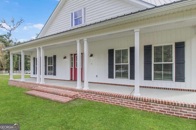 property entrance featuring a lawn and a porch