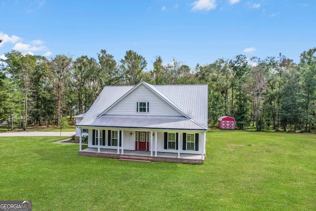 country-style home with a front lawn, a porch, and a storage unit