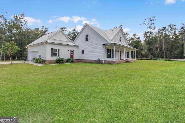 back of property featuring a porch, a yard, and a garage