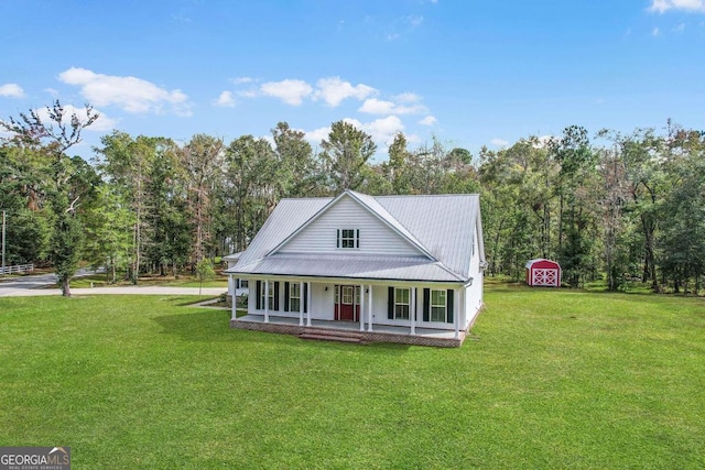 farmhouse with a storage unit, a front yard, and a porch