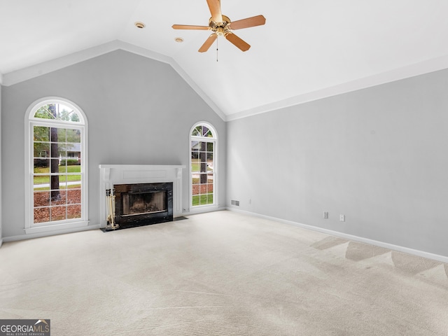 unfurnished living room with light carpet, ceiling fan, a fireplace, and baseboards