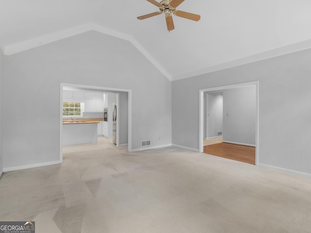 unfurnished living room featuring visible vents, ceiling fan, light carpet, and baseboards