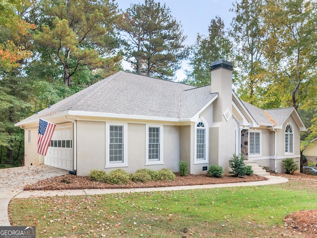 view of side of home with concrete driveway, a shingled roof, a chimney, and stucco siding