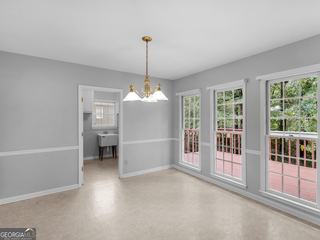 unfurnished dining area with baseboards, a wealth of natural light, and tile patterned floors