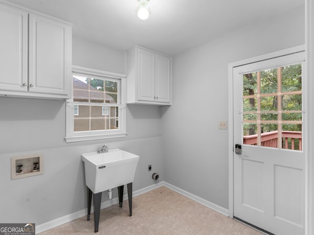 washroom featuring cabinet space, baseboards, hookup for a washing machine, light floors, and electric dryer hookup