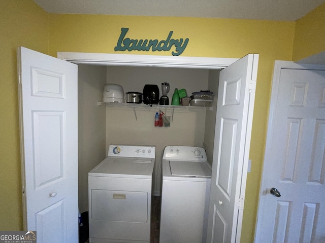 clothes washing area with washer and dryer