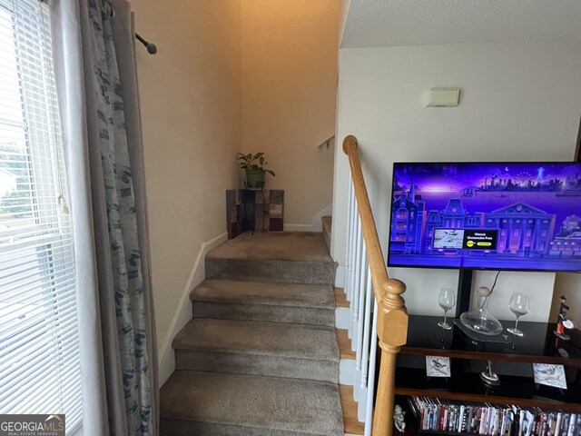 staircase with plenty of natural light