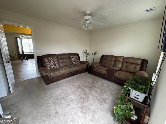 living room featuring carpet and ceiling fan