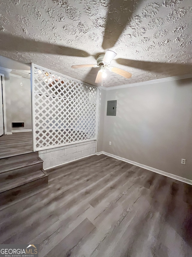 spare room with ornamental molding, ceiling fan, a textured ceiling, wood-type flooring, and electric panel