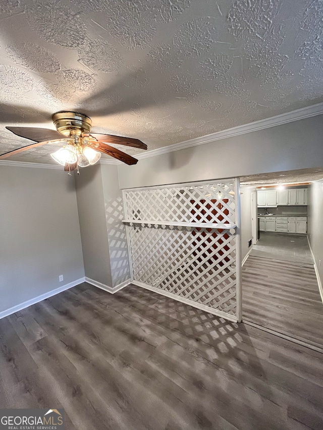 interior space featuring ornamental molding, a textured ceiling, ceiling fan, and dark hardwood / wood-style floors