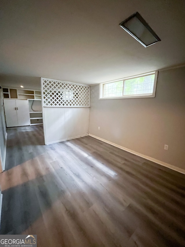 basement featuring dark hardwood / wood-style flooring