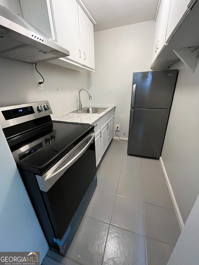 kitchen featuring stainless steel appliances, white cabinets, sink, light tile patterned floors, and exhaust hood