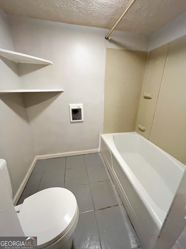 bathroom with shower / tub combination, tile patterned floors, toilet, and a textured ceiling