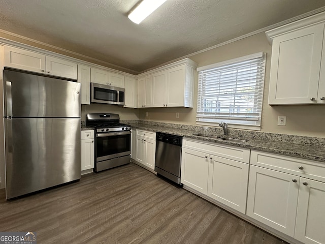 kitchen with white cabinets, dark hardwood / wood-style floors, sink, and appliances with stainless steel finishes