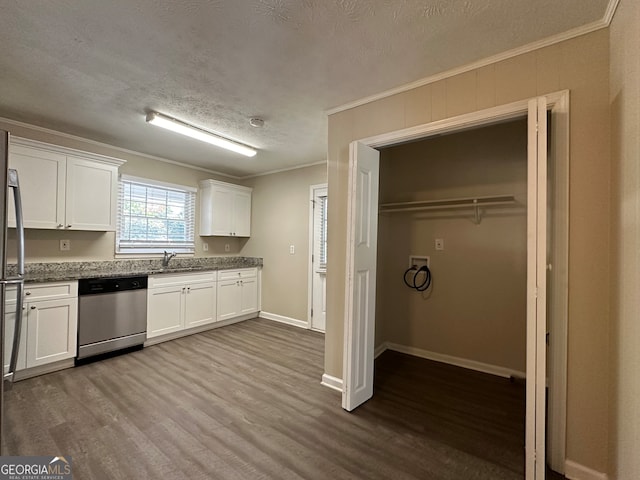 kitchen featuring hardwood / wood-style flooring, sink, appliances with stainless steel finishes, crown molding, and white cabinets