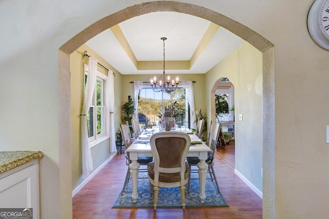 14 Rivendell Way, Hayesville, NC 28904 - dining room featuring arched walkways, a chandelier, dark wood-style floors, a tray ceiling, and a textured wall