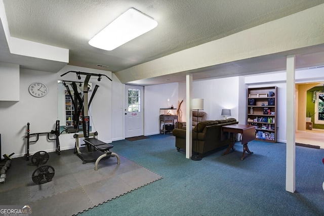 exercise room with carpet flooring and a textured ceiling