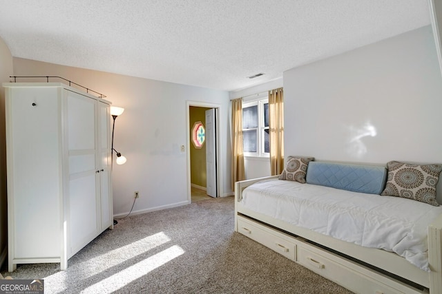 carpeted bedroom featuring a textured ceiling