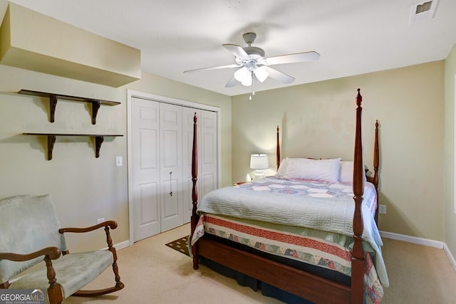 bedroom with light carpet, ceiling fan, and a closet