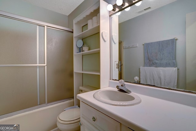 full bathroom with toilet, vanity, a textured ceiling, and enclosed tub / shower combo