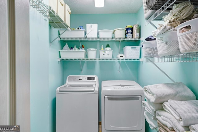 washroom featuring a textured ceiling and washer and dryer