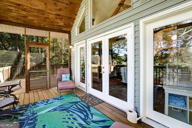 sunroom featuring french doors and lofted ceiling