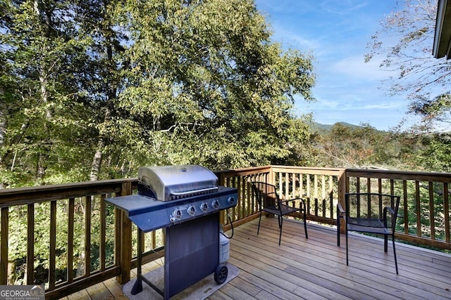 wooden terrace featuring area for grilling