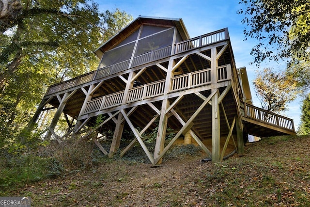 rear view of house featuring a deck